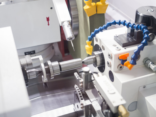 Operator Grinding Mold and Die Part Using CNC Universal Grinding Machine