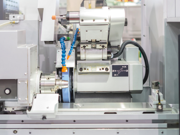 Finishing Metal Work Using High Precision Grinding Machine in Workshop